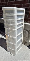 Front side view of white plastic storage tower showing all 8 drawers and overall structure