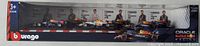 Front view of unopened box showing all six Red Bull Formula 1 cars and drivers featured in the set, with clear logos and numbering visible.