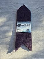 Photo of the folded Argonaut Tire Traction Runner with product label showing brand and set quantity.