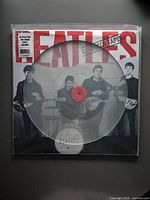 Front view of The Beatles The Decca Tapes vinyl album in original sleeve with clear vinyl picture disc visible.