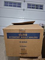 Cardboard box labeled ULINE Economy Bubble Mailers #0 Gold, size 6x10, indicating case originally contains 250 mailers.