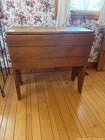 Front view of pine dough box standing on splayed legs