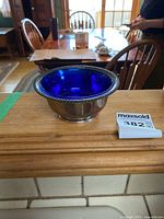 Sterling silver condiment bowl with cobalt blue glass insert shown from the front.