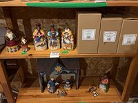 Shelf with Santa, tree and three Magi beside their original boxes