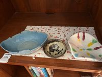 Top view of all three bowls arranged on a patterned cloth, showing size and color differences.
