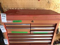 Front full view of the Craftsman metal tool chest showing 8 drawers and hinged top lid with lock, worn red paint, and silver drawer handles.