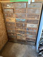 Front view of entire wooden cabinet showing 30 drawers