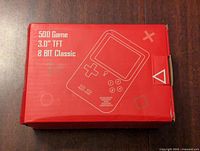 Red rectangular box for a 500 Game Player handheld console, 3.0 inch TFT screen, 8-bit classic style, with graphic showing console on top, slight edge wear