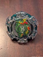 Top side of Beyblade Burst Kerbeus showing detailed flame design and emblem.