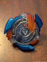 Top view showing the blue and orange plastic parts with a central 'V' emblem under transparent plastic.