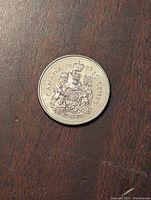 Reverse side of the 1993 Canadian 50 cent coin showing the Canadian coat of arms and denomination.