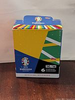 Front of Topps Euro 2024 sticker box showing branding, colors and pack count