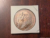 Obverse side of the bronze coin showing George Vancouver with spyglass and inscription.