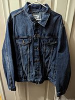Front view of Old Navy denim jean jacket on hanger showing button closures, chest pockets, and overall condition.