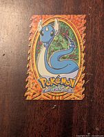 Front side of Pokemon Dragonair die cut card showing the Dragonair illustration with jagged orange border and Pokemon logo.