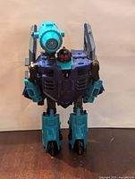 Front view of Transformers G2 Jetstorm figure showing blue/teal robot with red head and arm cannons.