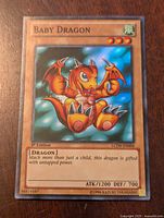 Front of the Yu-Gi-Oh! Baby Dragon card showing holographic artwork, text, and 1st Edition stamp.