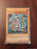 Front image of Blue-Eyes White Dragon Yu-Gi-Oh trading card showing the holographic art, name, stats and card details.