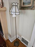 Full view of the standing floor lamp showing the stained glass shade and overall height.