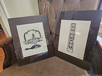 Two framed signed art pieces by Ferg featuring Indigenous motifs Thunderbird & Whale and Haida Lodge Pole.