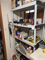 Plastic shelf with three tiers shown with items on shelves (not included).