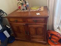 Side view of solid wood sideboard showing 8 drawers and 2 cabinet doors, some items on top not included