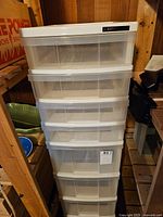 Photo showing full IRIS Mini Chest storage unit with six clear plastic drawers inside white frame.