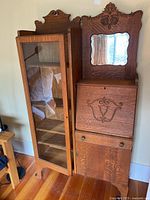 Front view of oak display cabinet and secretary desk side by side
