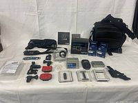 Full lot layout with camera, housings, mounts, batteries, remote, head strap, bag