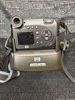 Rear view of HP PhotoSmart 945 on dock showing controls and LCD