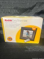 Retail box front showing Kodak EasyShare S510 5.6-inch digital picture frame and remote control.