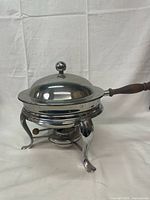 Full view showing chafing dish with lid, wooden handle and stand