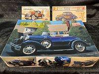 Group shot of all three model kit boxes showing artwork and titles