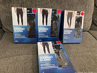 All four sealed retail boxes on sofa