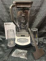 Blender base, pitcher, cups, tamper, manual, hardware bag