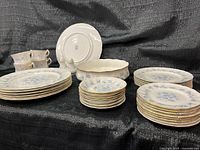 Overall view showing stacked plates, bowls, cups, serving bowl and shakers