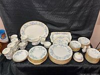 Entire set arranged showing plates, cups, serving pieces