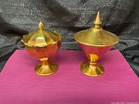 Two covered gold porcelain candy dishes