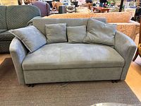 Front view of loveseat with four pillows