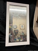 Front view showing white frame and mirror door