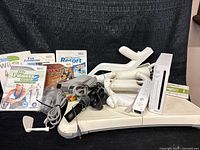 Group shot of console, balance board, games, controller and cables