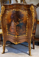 Front view showing painted front panel, ormolu mounts, and bombe shape.