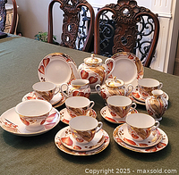 Overall arrangement showing entire dessert and tea service set on table