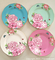 Four decorative Royal Albert plates showing different colored backgrounds and floral butterfly design.