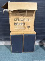 Pair of Kenwood KS-H51 speakers in original box. Wooden cabinets with black fabric covers. Box shows wear.