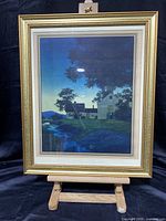 Front view of the framed Maxfield Parrish print depicting a twilight landscape with a house and creek.