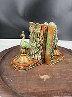 Pair of resin composite peacock bookends with green and brown coloring, showing the full set joined together.