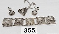 Full set of Peruvian sterling silver jewelry including wide bracelet, heart pendant necklace, and clip-on earrings all with elephant motifs.