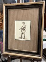 Full view of the framed vintage-style golfer print showing the frame, mat, and image of the golfer.