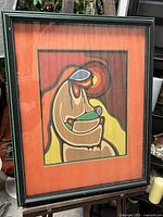 Framed colorful 'Mother and Child' print by Leland Bell with orange mat and black frame with green accents.